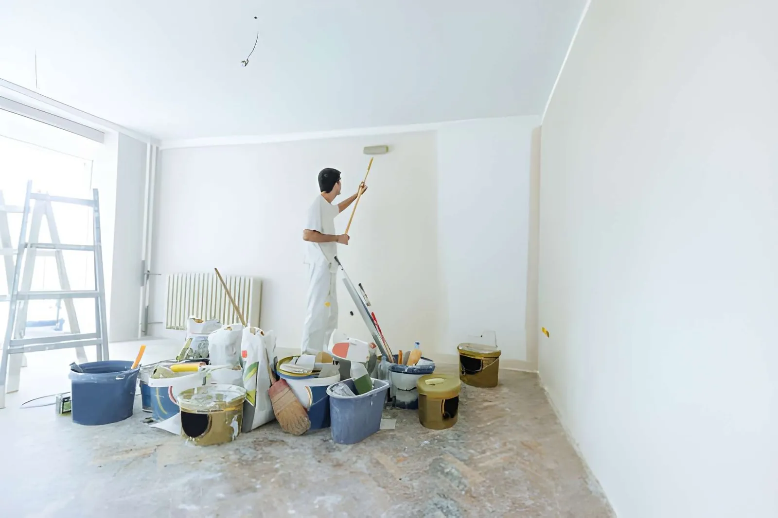 Professional painter working on a modern interior wall